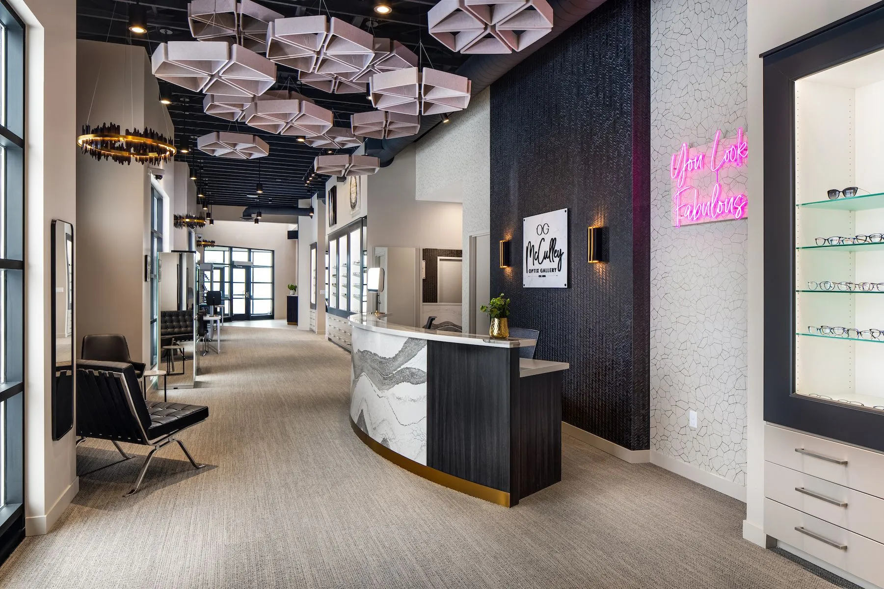 Contemporary interior of McCulley Optix Gallery featuring a stylish reception desk, designer lighting, and eyewear display areas - mcculley optix gallery