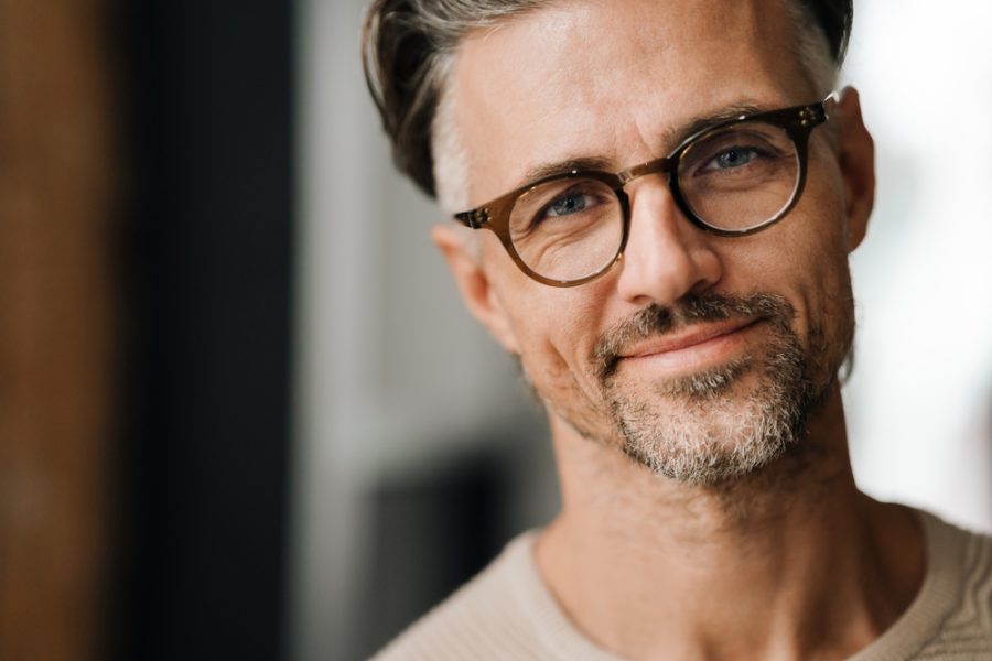 Stylish man wearing contemporary round eyeglasses that reflect current eyewear trends and modern fashion preferences - what style glasses are in fashion